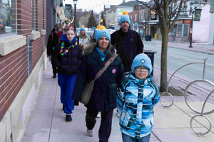 Shaheen Moledina, Candidate for Town of Aurora Councillor, Ward 4, walks along a local Aurora street during the Coldest Night of the Year charity walk. Accompanied by her son and fellow community members, Shaheen is seen wearing event-branded winter gear, showcasing her active participation in local initiatives and her deep-rooted connection to the town she has lived in since 2010.