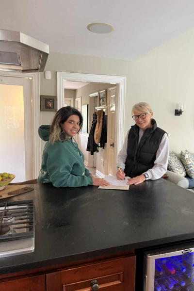 Shaheen Moledina, Candidate for Town of Aurora Councillor, Ward 4, stands in a kitchen alongside Leah Taylor Roy. Leah Taylor Roy, who served as a Member of the House of Commons for Aurora—Oak Ridges—Richmond Hill from 2021 to 2025, is shown signing an official endorsement document for Shaheen's campaign on a kitchen island. This image captures a key moment of political support from an experienced local leader, highlighting Shaheen’s connection to established community representation.